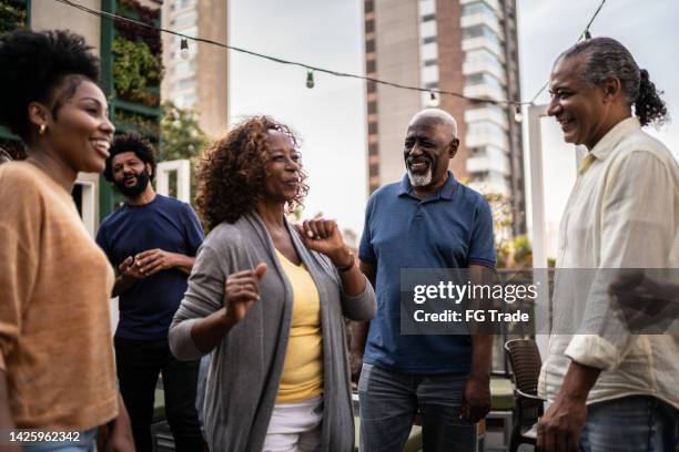 happy friends talking and dancing during happy hour - black dancer stock pictures, royalty-free photos & images