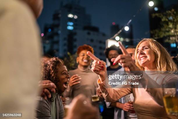 happy friends dancing during party at night - happy hour stockfoto's en -beelden