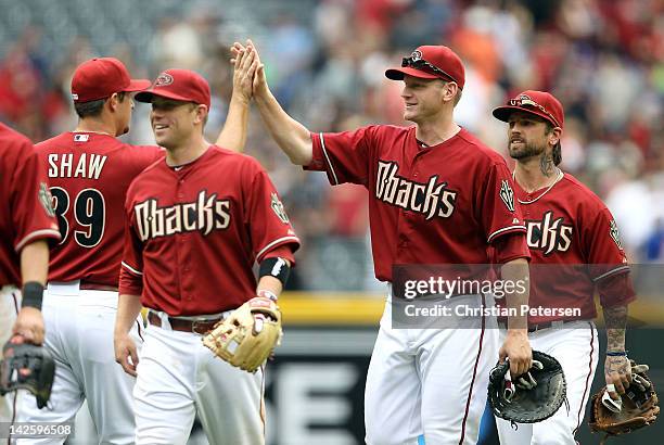 Lyle Overbay of the Arizona Diamondbacks high-fives relief pitcher Bryan Shaw after defeating the San Francisco Giants in the MLB game at Chase Field...