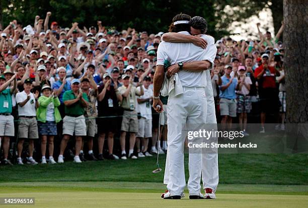 Bubba Watson of the United States hugs his caddie Ted Scott after winning his sudden death playoff on the second playoff hole to win the 2012 Masters...