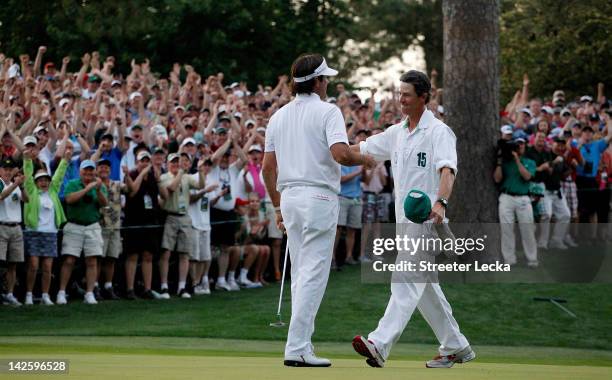 Bubba Watson of the United States hugs his caddie Ted Scott after winning his sudden death playoff on the second playoff hole to win the 2012 Masters...