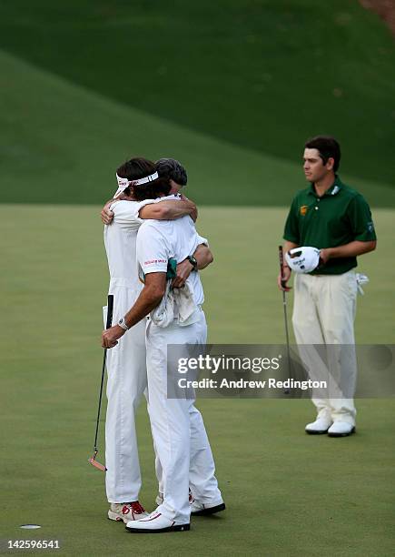Bubba Watson of the United States hugs his caddie Ted Scott after winning his sudden death playoff on the second playoff hole to win the 2012 Masters...