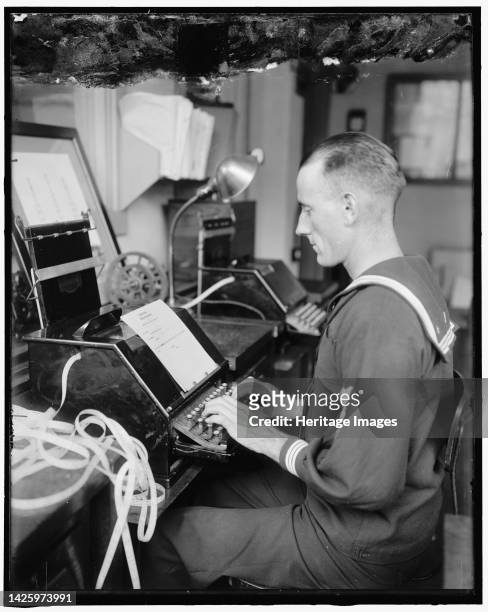 Radio, 1919. USA. Sailor typing at ticker tape machine: 'Leased wire telegram received at Navy Department...New York Oct 23 1919, I P Bemberg,...