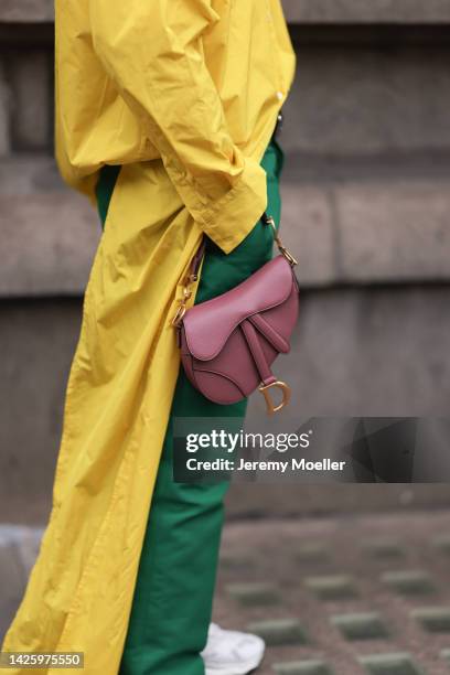 Fashion week guest seen wearing a colourblocking dress and a dior mini saddle bag, outside simone rocha during London Fashion Week September 2022 on...