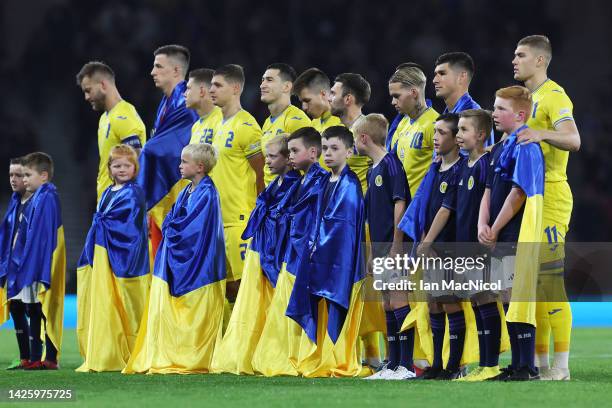 Ukraine players pass their team flags to match mascots on pitch prior to the UEFA Nations League League B Group 1 match between Scotland and Ukraine...