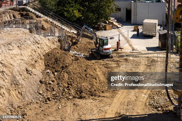 bulldozer is working in a sand pit. - hydraulisch platform stockfoto's en -beelden