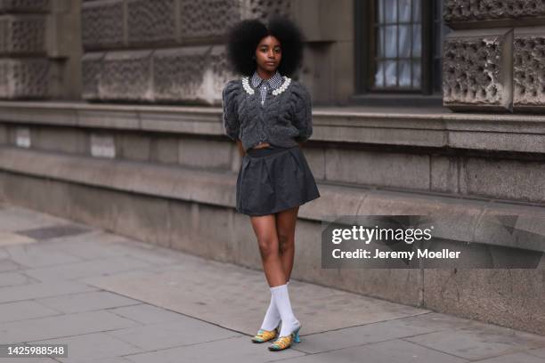 Floweroflove aka Joyce seen wearing mini skirt with a cozy pullover, outside simone rocha during London Fashion Week September 2022 on September 18,...