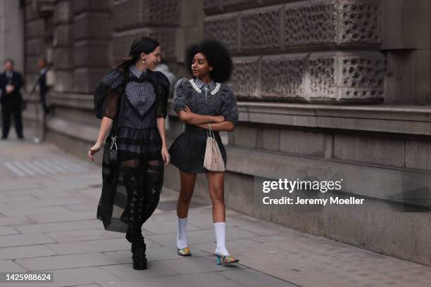 Floweroflove aka Joyce and a fashion week guest seen wearing grey and black looks, outside simone rocha during London Fashion Week September 2022 on...