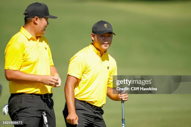 Sungjae Im of South Korea and the International Team and Si Woo Kim of South Korea and the International Team talk during a practice round prior to...