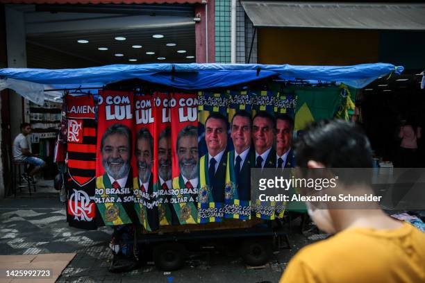 Street vendors sell towels with images of presidential candidates Lula da Silva and Jair Bolsonaro in downtown Sao Paulo ahead of Presidential...