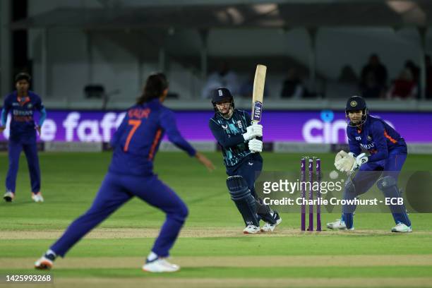 Charlie Dean of England hits out while Yastika Bhatia of India tends the wicket during the 2nd Royal London ODI between England Women and India Women...