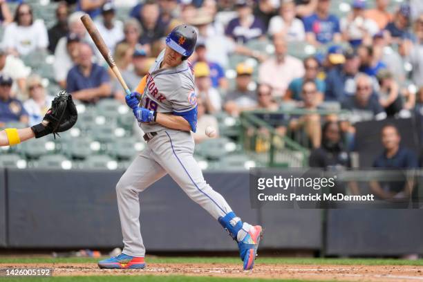 Mark Canha of the New York Mets is hit by a pitch by Adrian Houser of the Milwaukee Brewers in the fifth inning during a game at American Family...