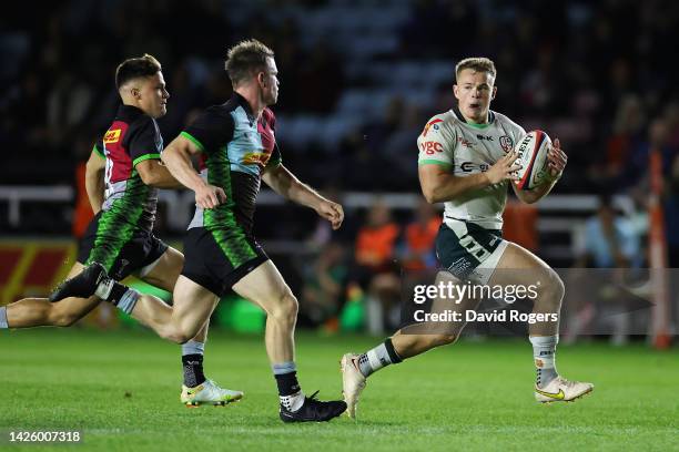 Tom Hitchcock of London Irish breaks with the ball during the Premiership Rugby Cup match between Harlequins and London Irish at The Stoop on...