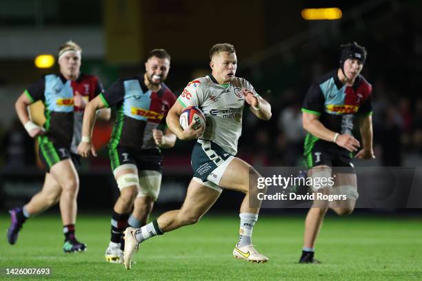 Tom Hitchcock of London Irish breaks with the ball during the Premiership Rugby Cup match between Harlequins and London Irish at The Stoop on...