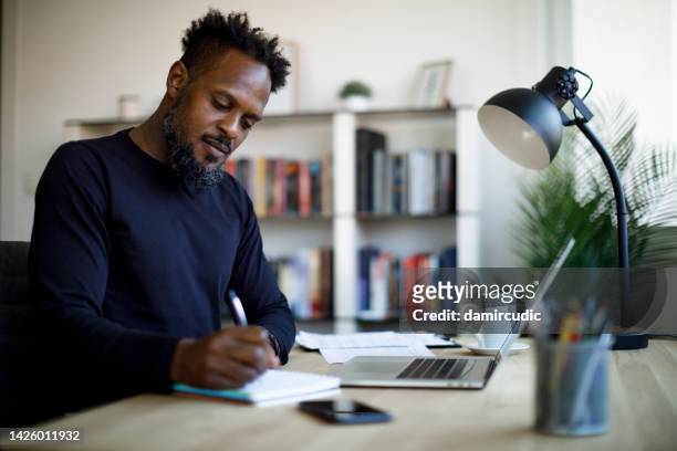 adult male student studying at home - test preparation stock pictures, royalty-free photos & images