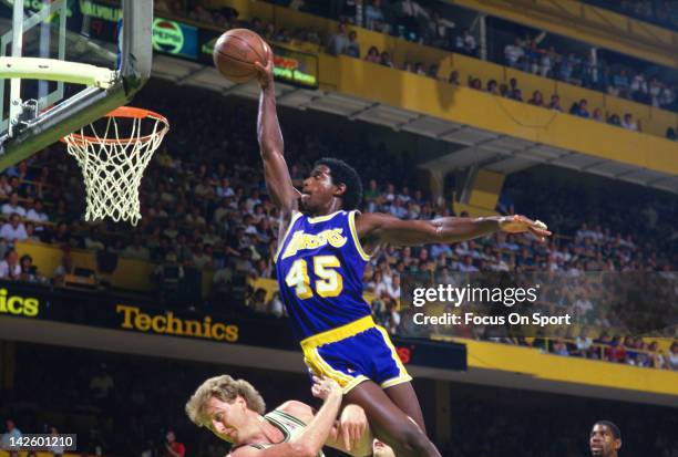 Green of the Los Angeles Lakers jams the ball over Larry Bird of the Boston Celtics during the 1987 NBA Basketball Finals at the Boston Garden in...