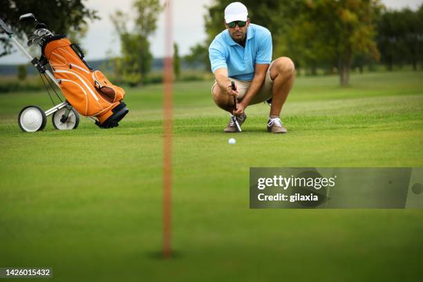 young man at a golf course. - golf clubhouse stockfoto's en -beelden