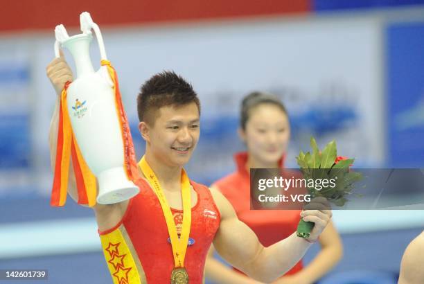 Gold medalist Chen Yibing of China stands on the podium after winning the Rings fainal during the FIG World Cup Zibo 2012 at Zibo Sports Center on...