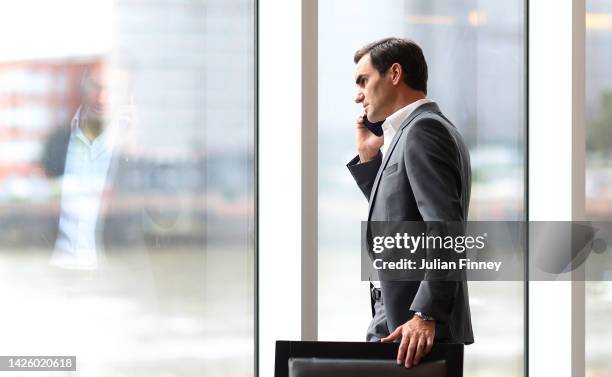 Roger Federer of Team Europe talks on the phone on as players prepare for a photoshoot on September 21, 2022 in London, England.