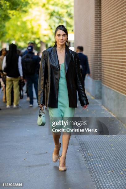 Brittany Xavier wears mint green dress, black leather blazer, bag, beige heels outside Fendi during the Milan Fashion Week - Womenswear Spring/Summer...