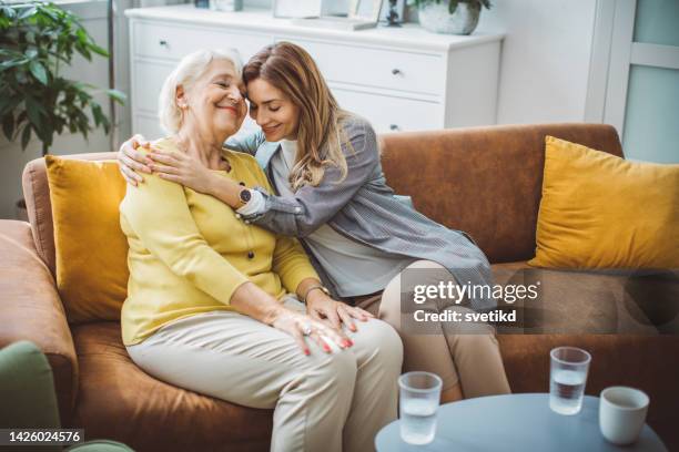 mujer mayor hablando con su hija - asistencia de la comunidad fotografías e imágenes de stock