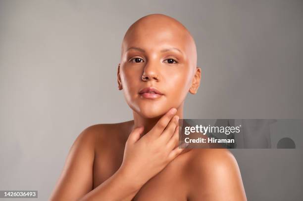 clean skincare face, bald black woman and cancer beauty model with body jewelry. portrait of beautiful girl, clear shine natural cosmetic makeup and beautiful lady with alopecia on grey background - alopecia stockfoto's en -beelden