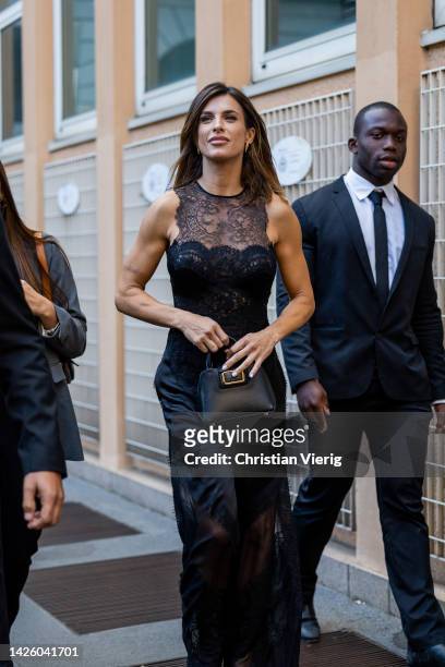 Italian actress Elisabetta Canalis wears black laced overall, bag outside Alberta Ferretti during the Milan Fashion Week - Womenswear Spring/Summer...