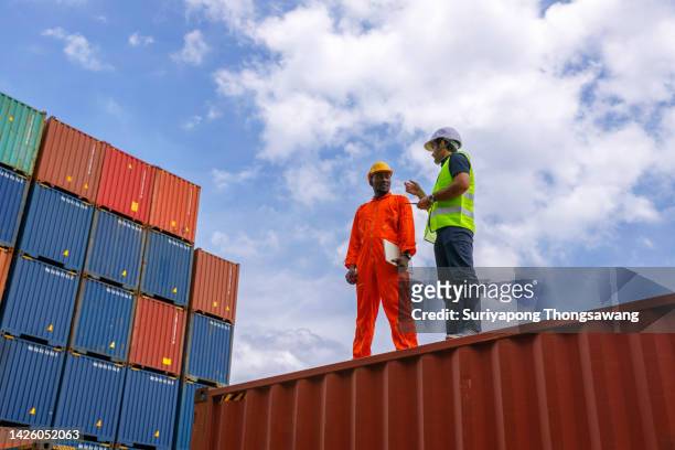foreman taking to worker for quality control shipping process in container warehouse for business logistics, import export shipping or freight transportation. - white style at quay stock pictures, royalty-free photos & images