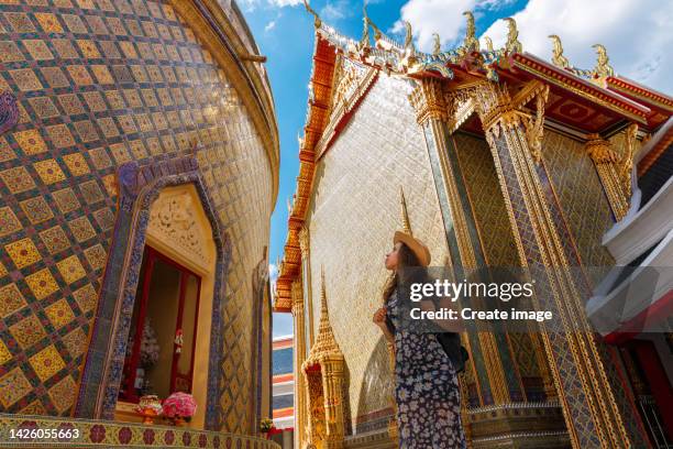young latin women tourist smiling and happy on holiday, impressive in beautiful temple in bangkok, thailand. for summer or holiday concept background. - thailand tourism stock pictures, royalty-free photos & images