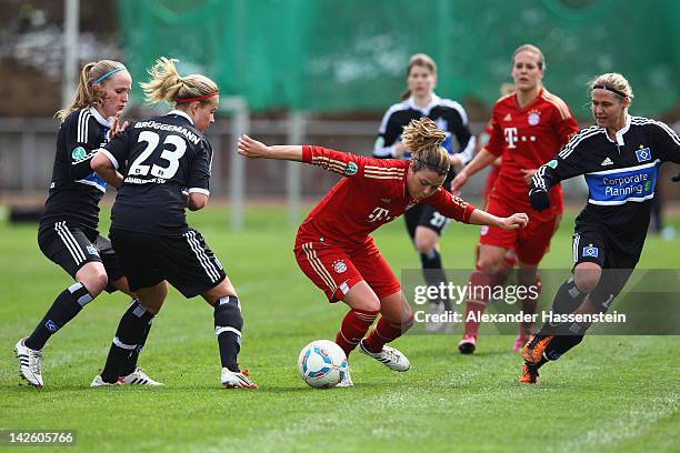 Isabell Bachor of Muenchen battles for the ball with Nina Brueggemann of Hamburg and her team mate Maja Schubert during the Women's DFB Cup semi...