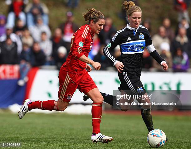 Isabell Bachor of Muenchen battles for the ball with Marie-Louise Bagehorn of Hamburg during the Women's DFB Cup semi final match between FC Bayern...