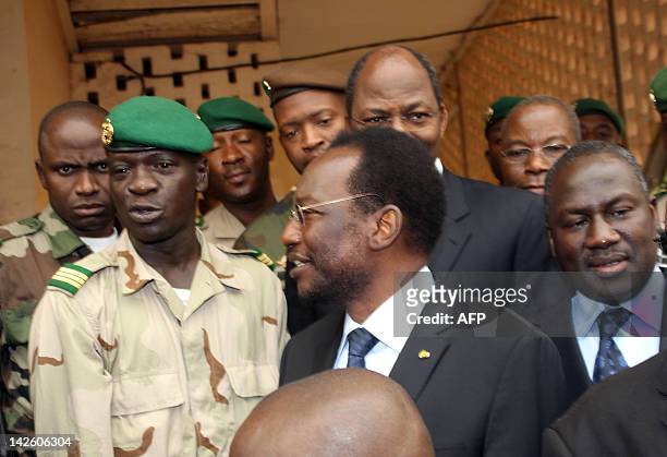 Mali's speaker of parliament Dioncounda Traore stands next to Captain Amadou Sanogo after they met on April 9, 2012 at the Kati military barracks...