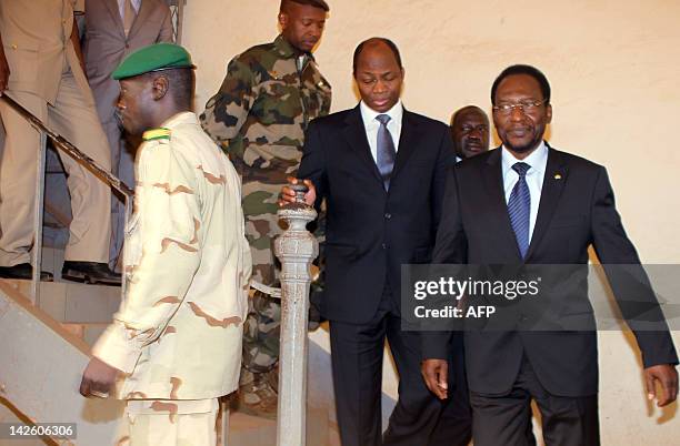 Mali's speaker of parliament Dioncounda Traore follows Captain Amadou Sanogo after they met on April 9, 2012 at the Kati military barracks outside...