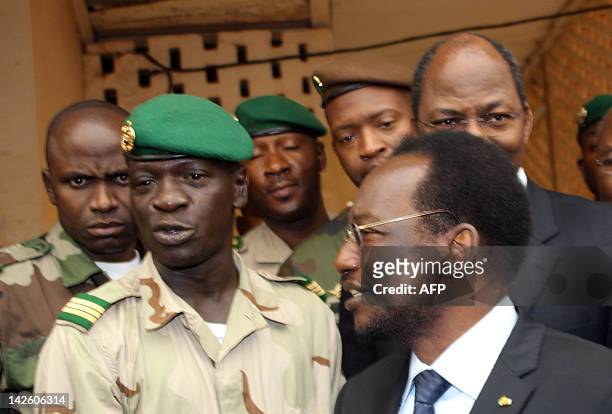 Mali's speaker of parliament Dioncounda Traore stands next to Captain Amadou Sanogo after they met on April 9, 2012 at the Kati military barracks...