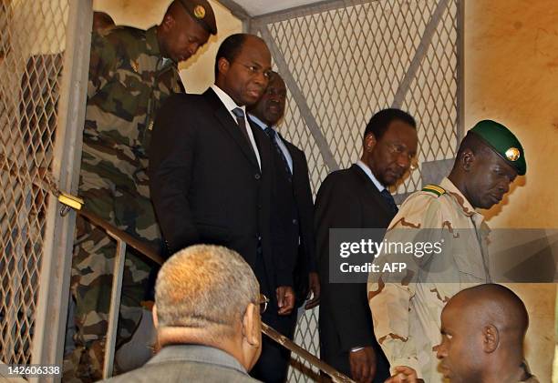 Mali's speaker of parliament Dioncounda Traore follows Captain Amadou Sanogo after they met on April 9, 2012 at the Kati military barracks outside...