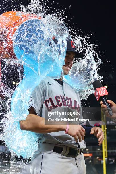 Steven Kwan and Myles Straw of the Cleveland Guardians give Will Brennan a Gatorade bath after his MLB debut against the Chicago White Sox at...