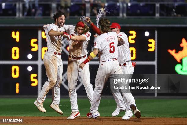 Matt Vierling, Alec Bohm, Bryson Stott and Donny Sands of the Philadelphia Phillies celebrate a walk off single hits a by Vierling to defeat the...