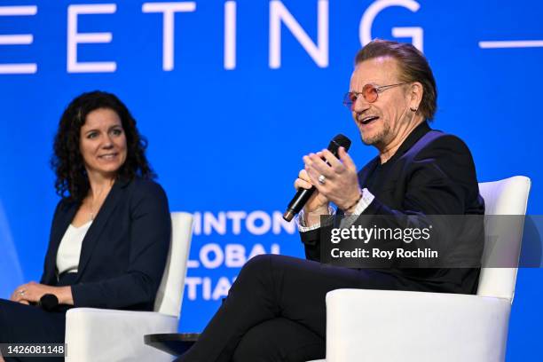 Karen Miga and Bono Vox speak during the Clinton Global Initiative September 2022 Meeting at New York Hilton Midtown on September 20, 2022 in New...