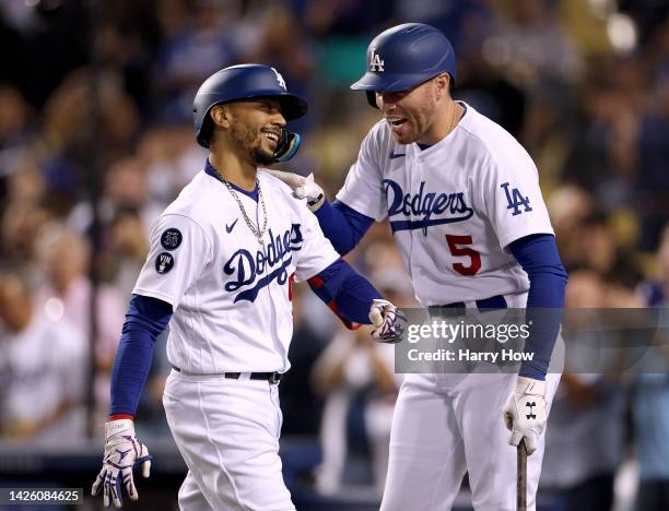 Mookie Betts of the Los Angeles Dodgers celebrates his solo homerun with Freddie Freeman, to trail the Arizona Diamondbacks 5-1, during the fourth...