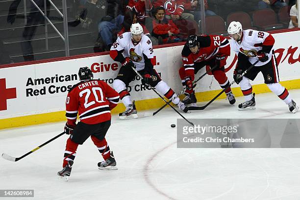Rob Klinkhammer and Jesse Winchester of the Ottawa Senators fight for the puck against Ryan Carter and Cam Janssen of the New Jersey Devils at...
