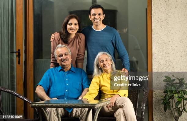two generation family spending leisure time at home - daughter in law stock pictures, royalty-free photos & images