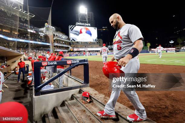 Albert Pujols of the St. Louis Cardinals returns to the dugout after flying out during the fourth inning of a game against the San Diego Padres at...