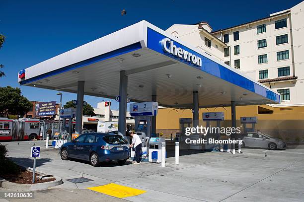 Customers buy fuel at a Chevron Corp. Gasoline station in San Francisco, California, U.S., on Friday, April 6, 2012. Gasoline slid to a four-week low...