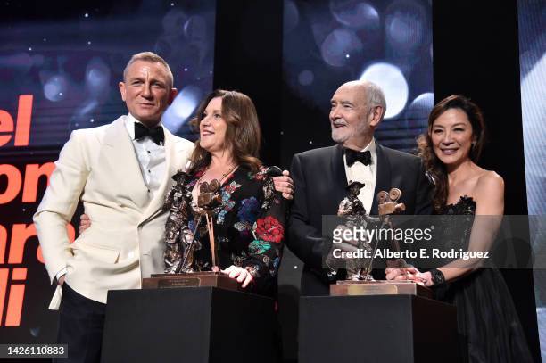 Daniel Craig, Barbara Broccoli, Michael G. Wilson and Michelle Yeoh pose onstage during Will Rogers Motion Picture Pioneers Foundation's 2022 Pioneer...