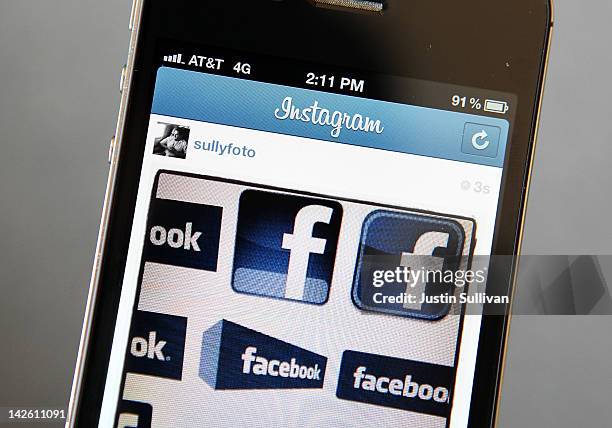 In this photo illustration, an Instagram photo of various Facebook logos are seen on an Apple iPhone on April 9, 2012 in New York City. Facebook Inc....