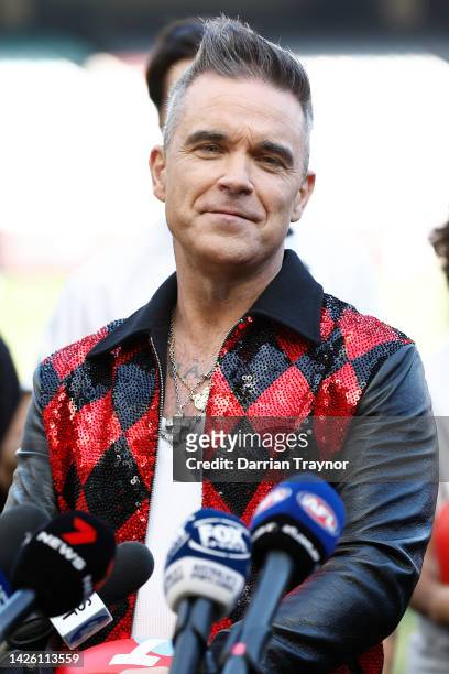 Robbie Williams speaks to the media during the AFL Grand Final entertainment media opportunity at Melbourne Cricket Ground on September 22, 2022 in...