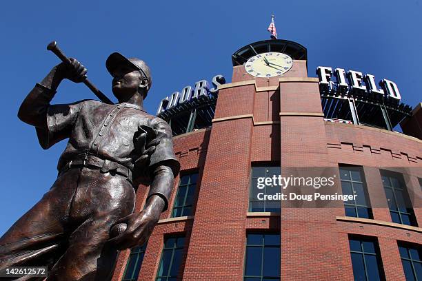 The statue of 'The Player' stands watch outside the stadium as the San Francisco Giants face the Colorado Rockies on Opening Day at Coors Field on...