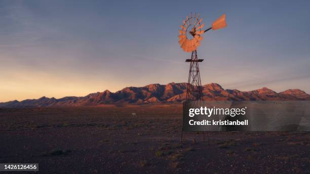 windmill pumping water in rural outback landscape, australia - beautiful nature stock pictures, royalty-free photos & images