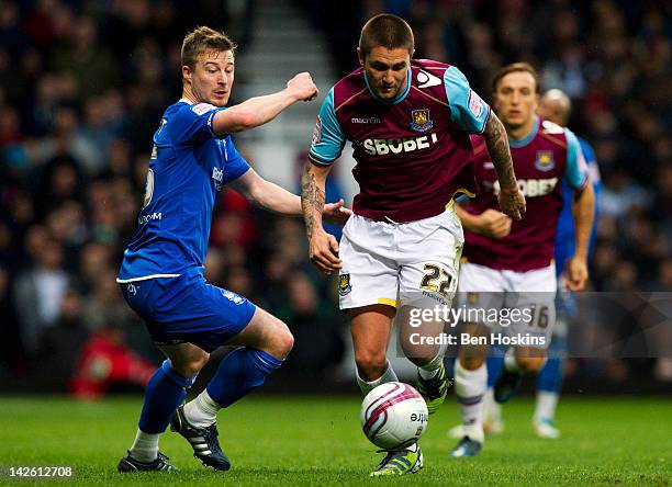 Henri Lansbury of West Ham holds off pressure from Wade Elliot of Birmingham during the npower Championship match between West Ham United and...