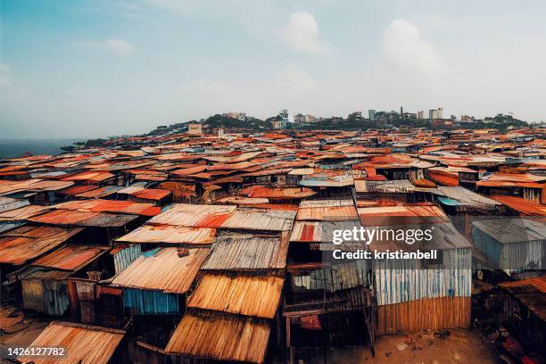 digitally generated image of makeshift shacks in a poverty stricken city slum - favela stock-fotos und bilder